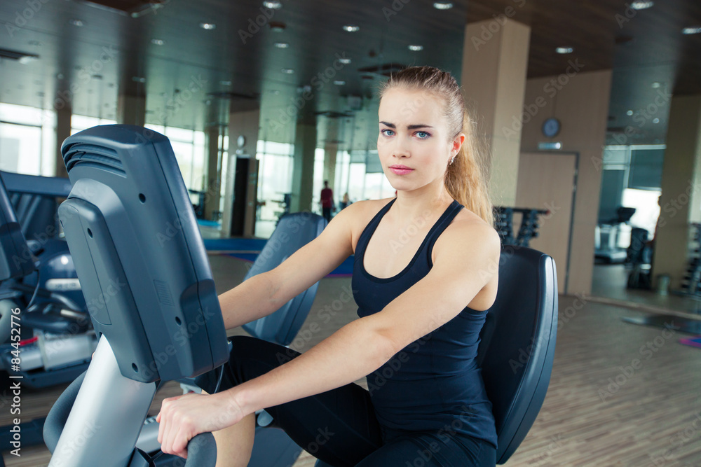 beautiful girl doing indoor biking in a fitness club beautiful girl doing indoor biking in a fitness club