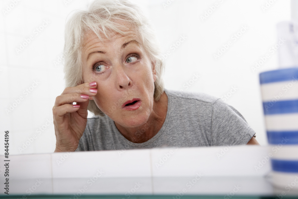 Senior Couple Woman Looking At Reflection In Mirror For Signs Of Ageing Senior Couple Woman Looking At Reflection In Mirror For Signs Of Ageing
