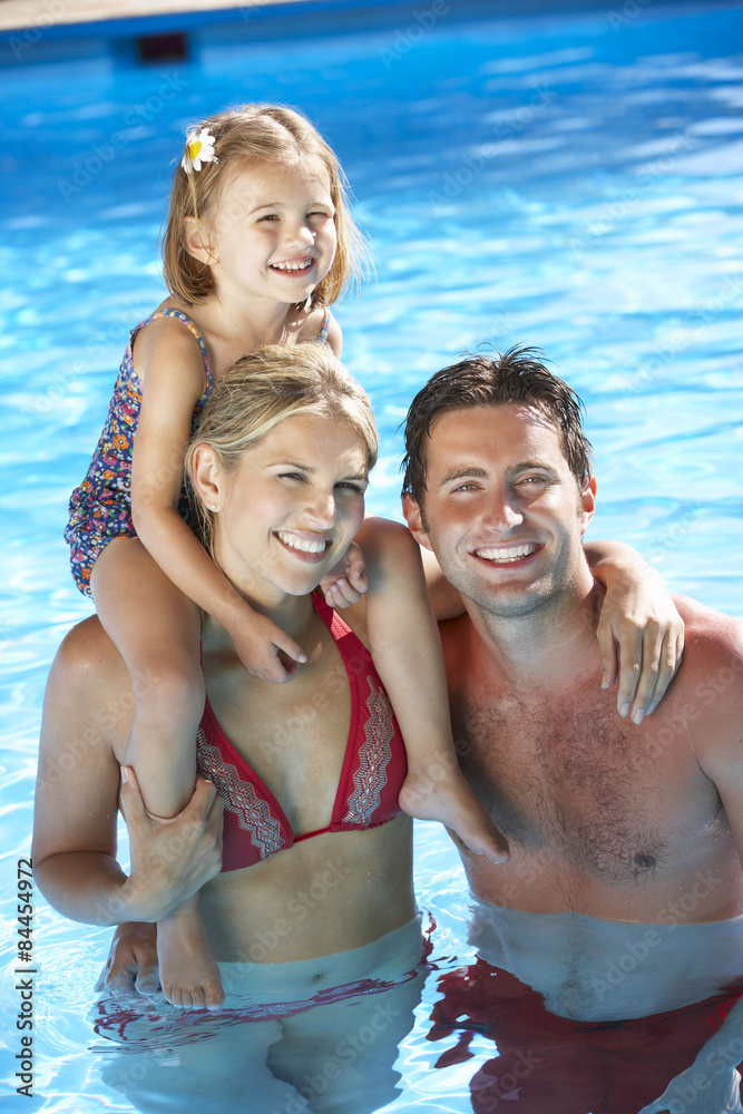 Obraz premium Family On Holiday In Swimming Pool