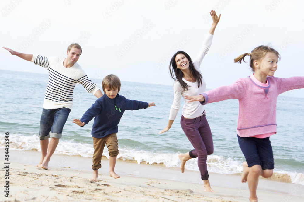 Family Playing On Beach Together