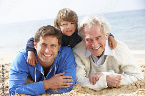 Multi Generation Family Lying On Beach Together © Monkey Business