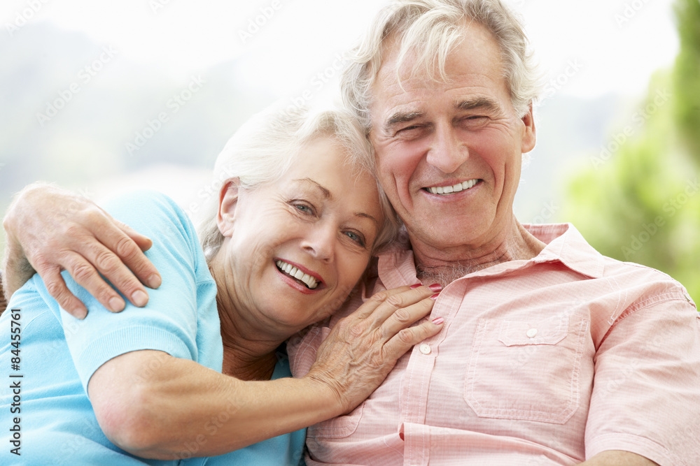 Senior Couple Sitting On Outdoor Seat Together Senior Couple Sitting On Outdoor Seat Together
