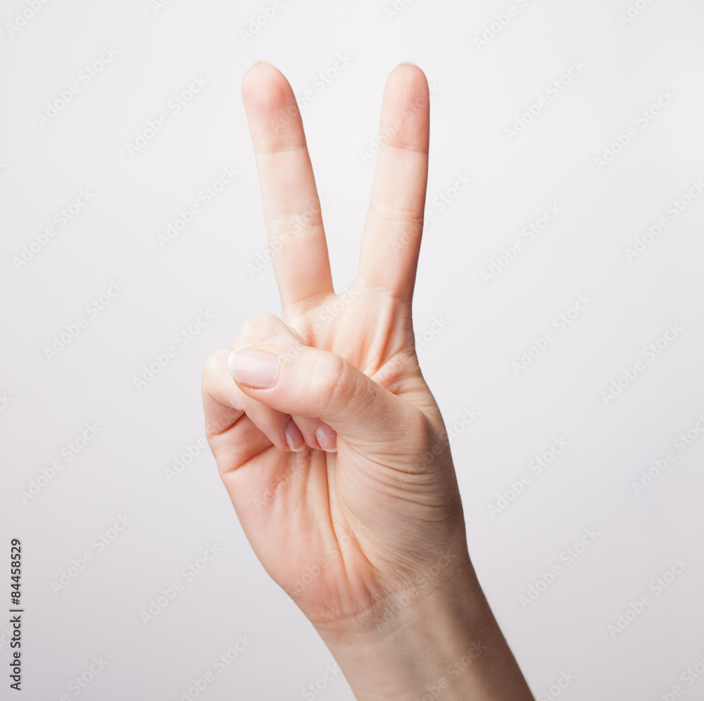 Counting gesture, women's hand showing two fingers, isolated on Counting gesture, women's hand showing two fingers, isolated on