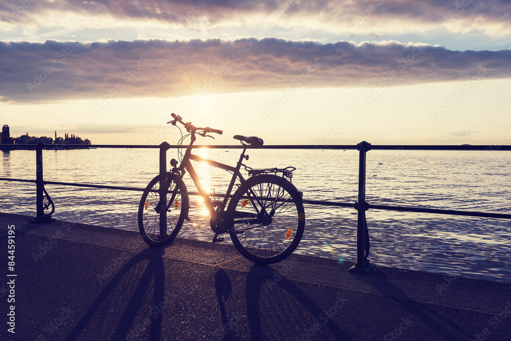 Fototapeta premium Bicycle leaning on the railing on the waterfront of Lake Constance. Bodensee.