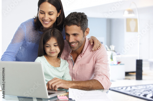 Family Working At Laptop With In Home Office © Monkey Business