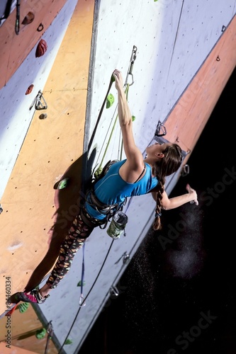 Female sport climber on the climbing wall