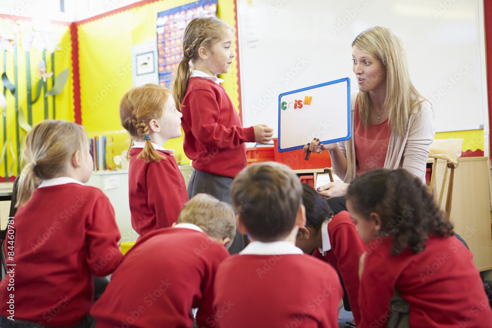 Fototapeta premium Teacher Teaching Spelling To Elementary School Pupils