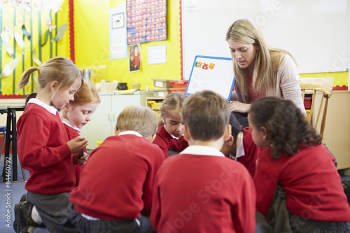 Teacher Teaching Spelling To Elementary School Pupils