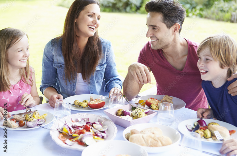 Family Enjoying Outdoor Meal Together