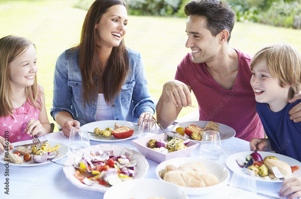 Family Enjoying Outdoor Meal Together Family Enjoying Outdoor Meal Together