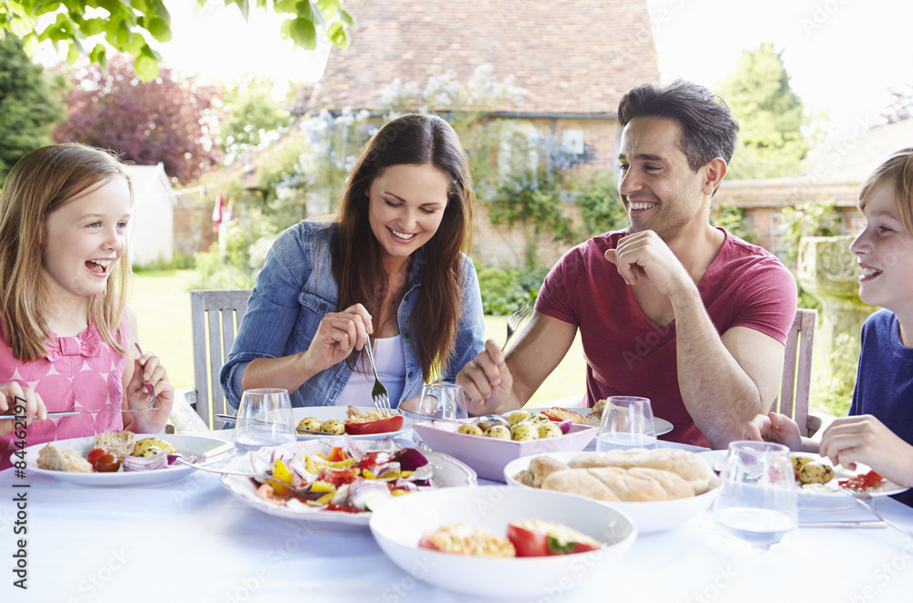 Family Enjoying Outdoor Meal Together