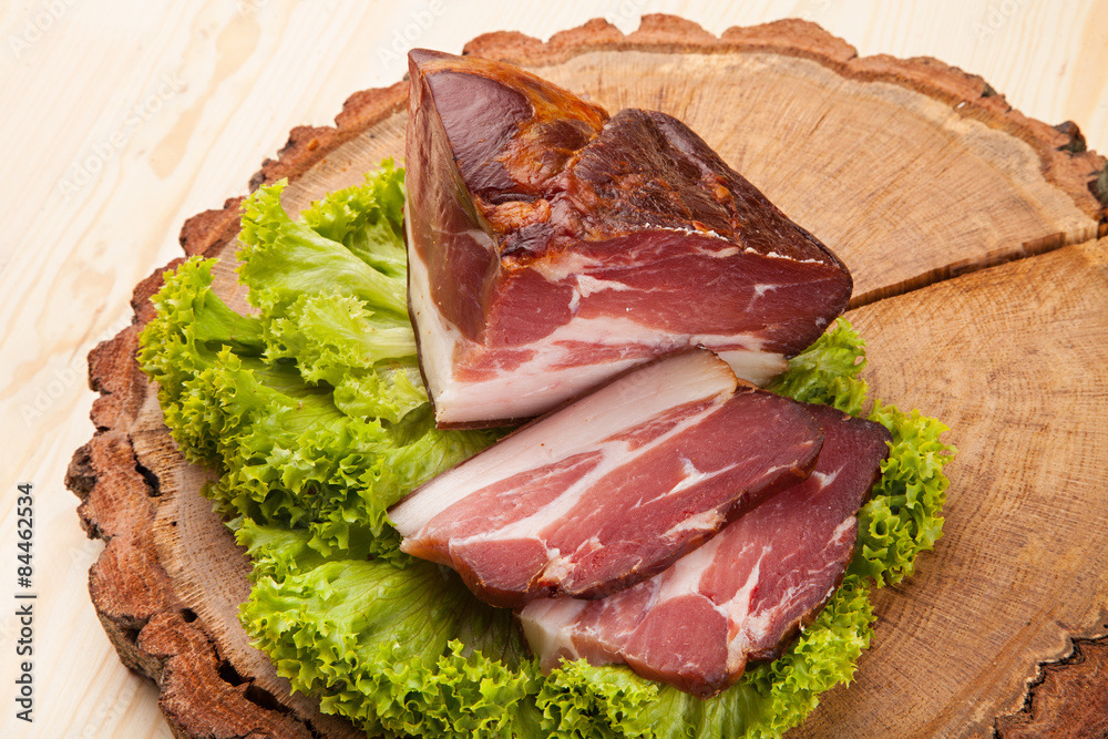 Smoked meat with bright summer vegetables on wooden background Smoked meat with bright summer vegetables on wooden background