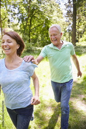 Senior Couple Running In Summer Countryside