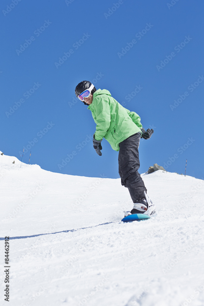 Man Snowboarding On Ski Holiday In Mountains Man Snowboarding On Ski Holiday In Mountains