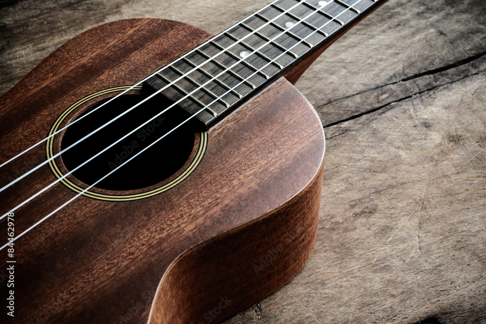 Obraz premium Close up of ukulele on old wooden background