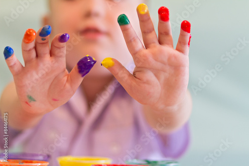 boy draws paints, finger paints