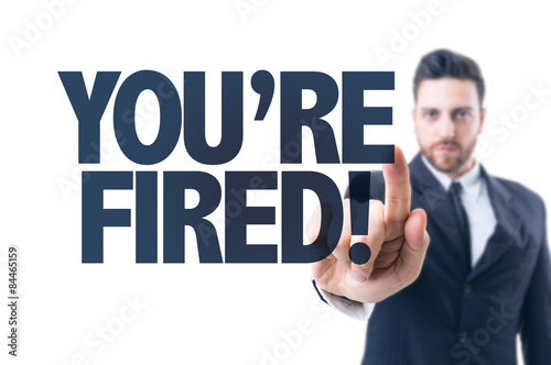 Business man pointing the text: You're Fired!
