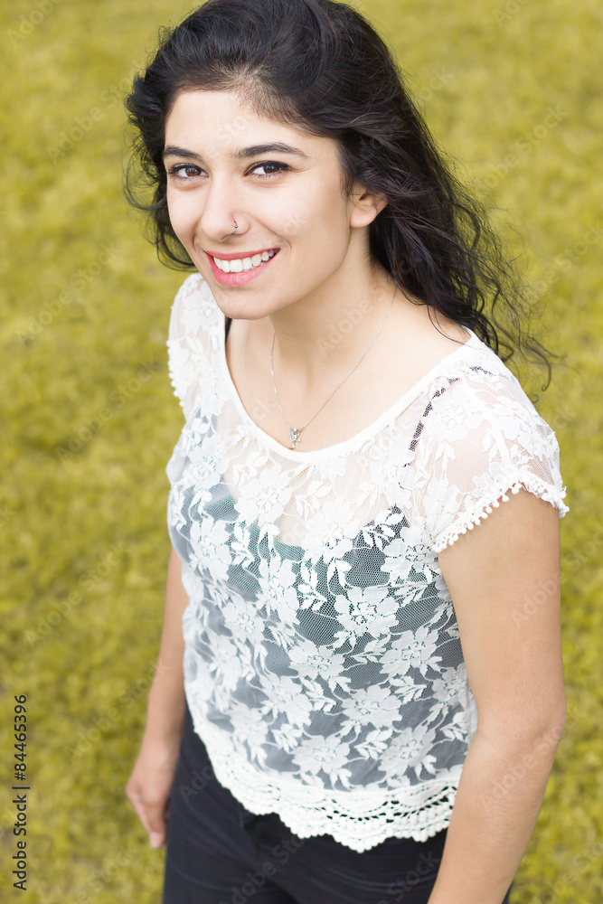 smiling young beautiful woman posing outdoors