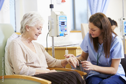 Senior Woman Undergoing Chemotherapy With Nurse photo