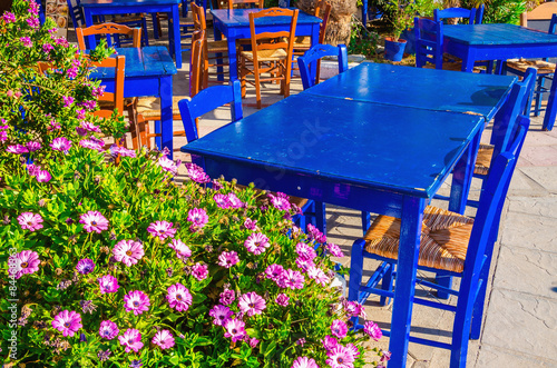 Blue tables in colorful Greek restaurant, Greece