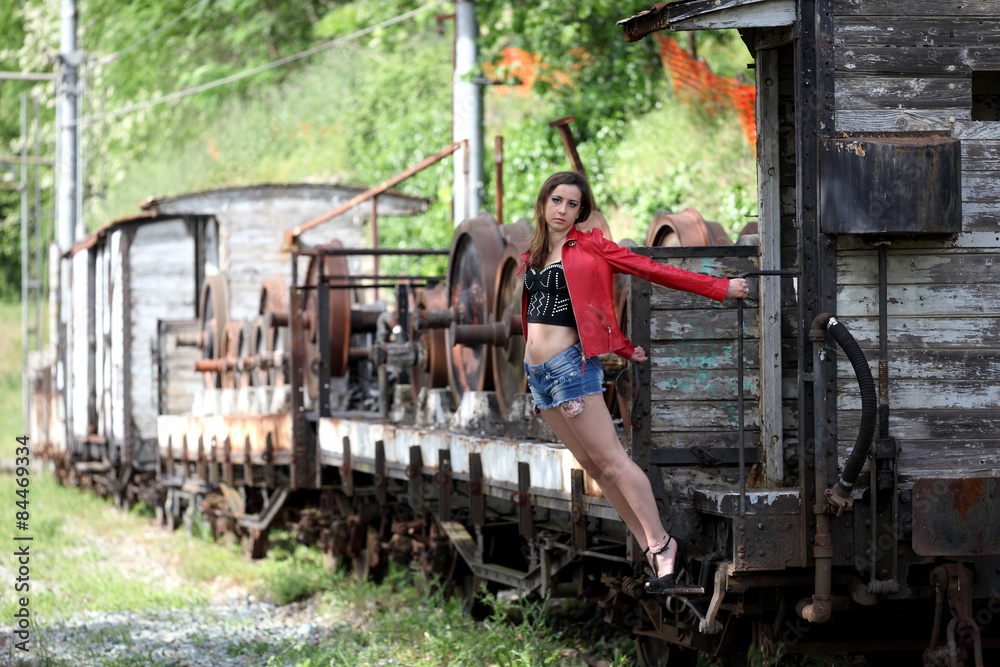 Beautiful young woman and vintage train