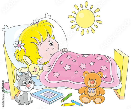 Little girl waking up in her small bed