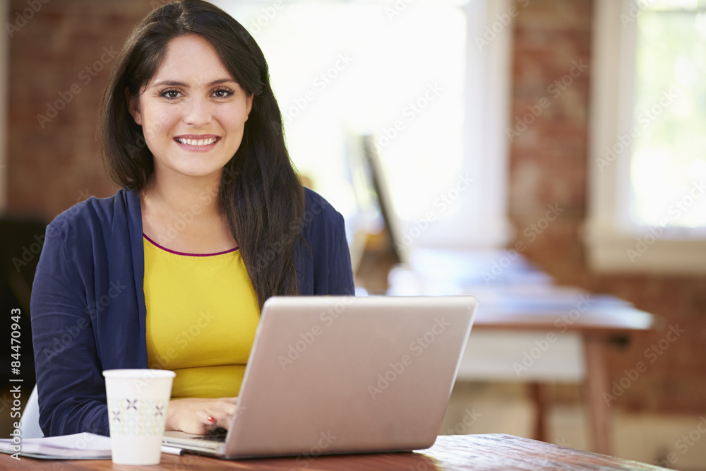 Woman Working At Laptop In Contemporary Office Woman Working At Laptop In Contemporary Office