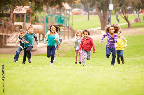 Group Of Young Children Running Towards Camera In Park