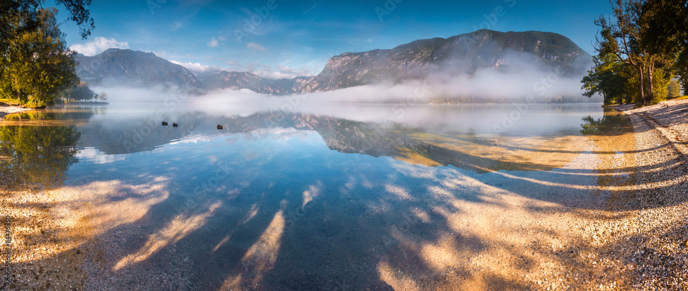 Panorama of foggy summer morning on the Bohinj lake