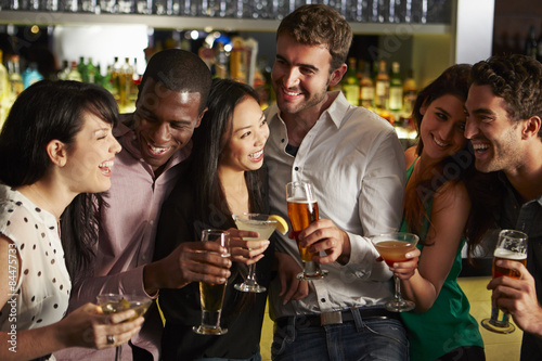 Group Of Friends Enjoying Drink In Bar