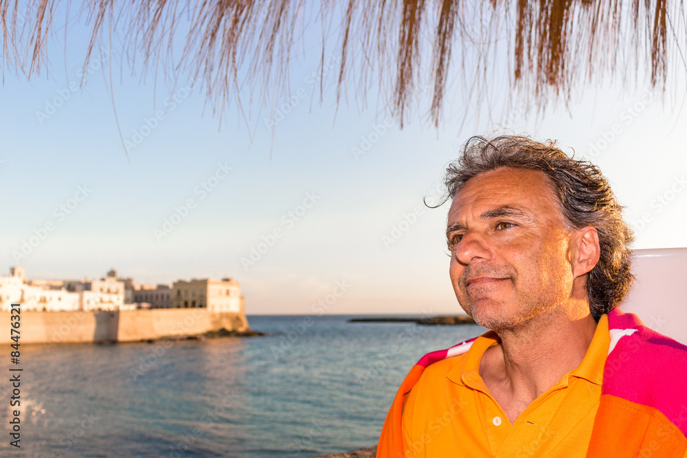 Fototapeta premium Handsome tanned relaxed man on holiday in Italy