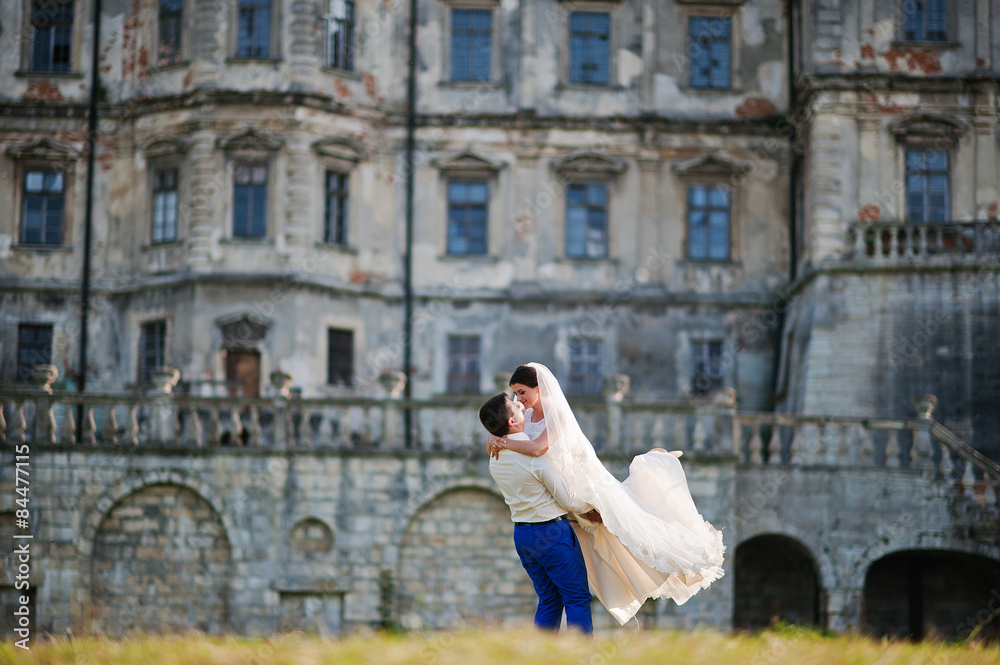 Young wedding couple on background old castle