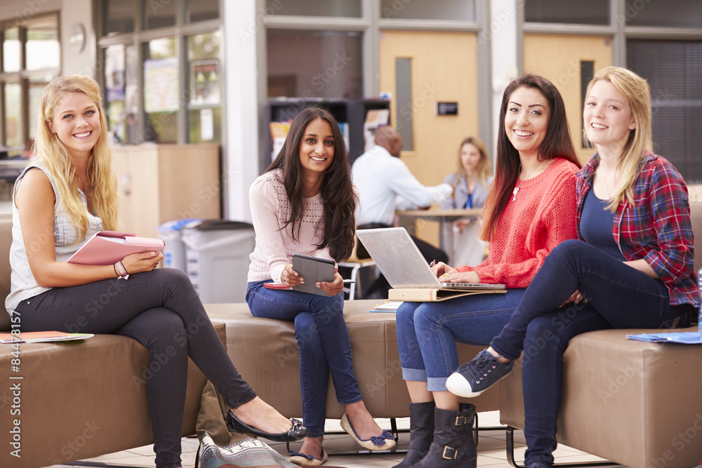 Female College Students Sitting And Talking Together Female College Students Sitting And Talking Together