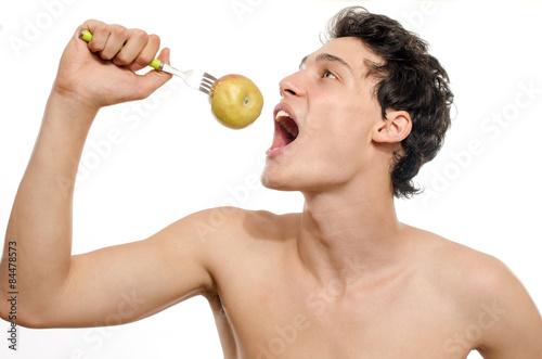 Young man choosing to eat an organic, healthy apple for a perfect diet