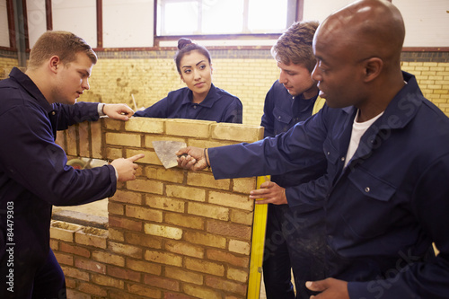 Photography Teacher Helping Students Training To Be Builders