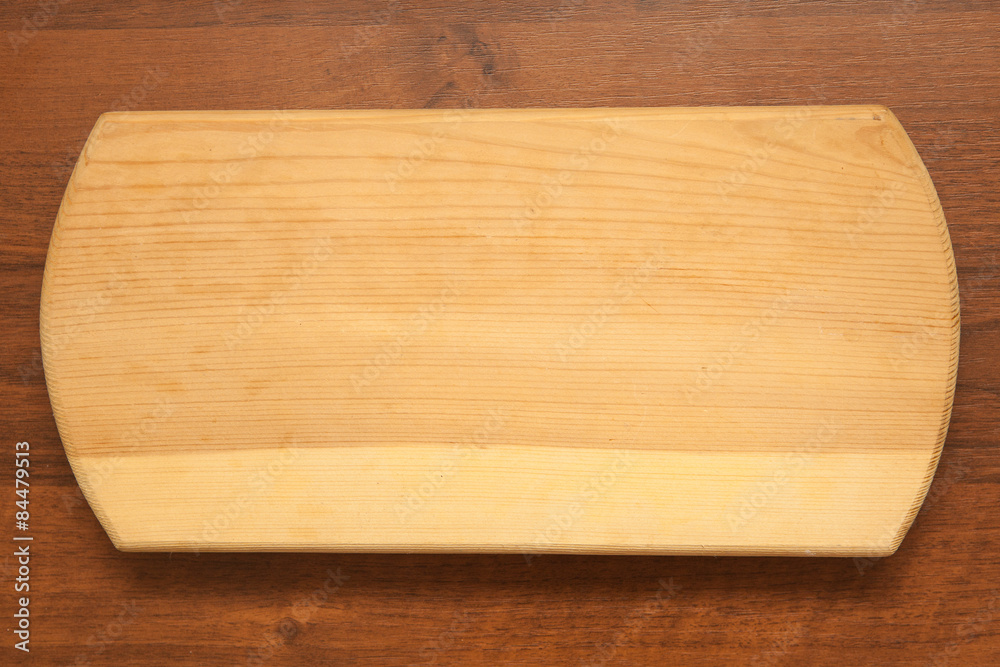 Empty cutting board on a wooden background