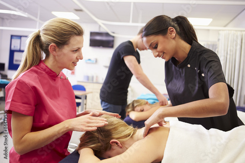 Obraz na plátne Teacher Helping Student Training To Become Masseuse