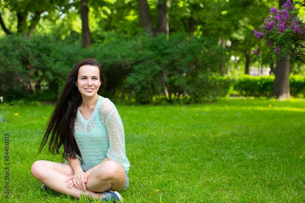 Fototapeta premium young girl in a park on the grass