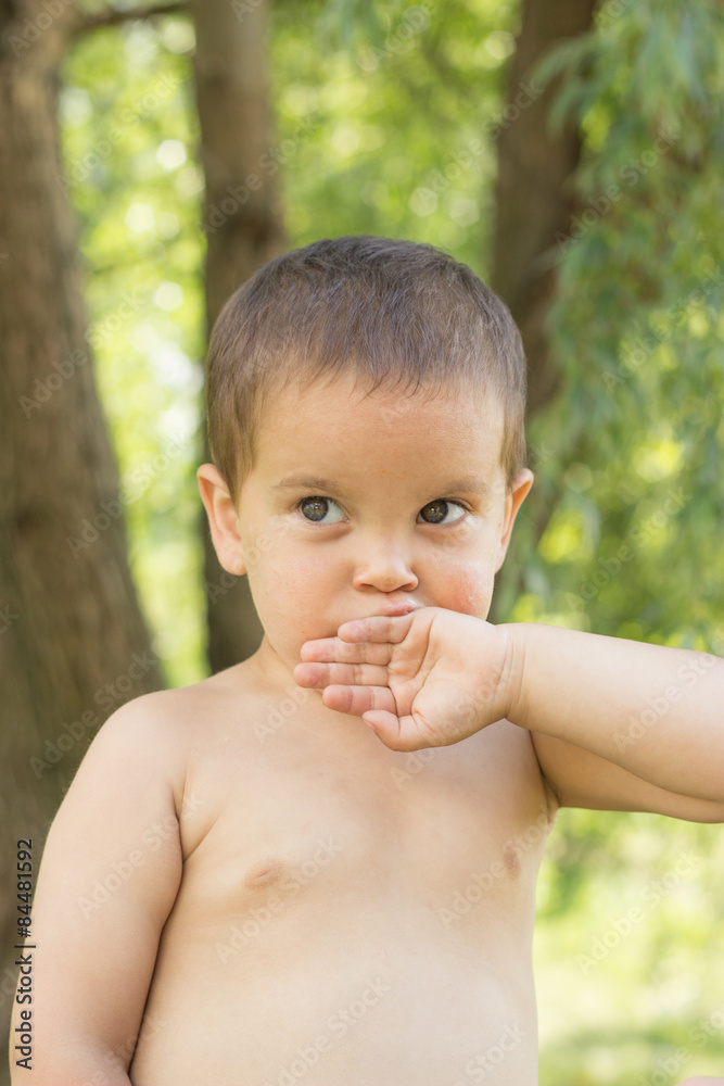 a little boy, two years old, smiling, summer, naked to the waist a little boy, two years old, smiling, summer, naked to the waist
