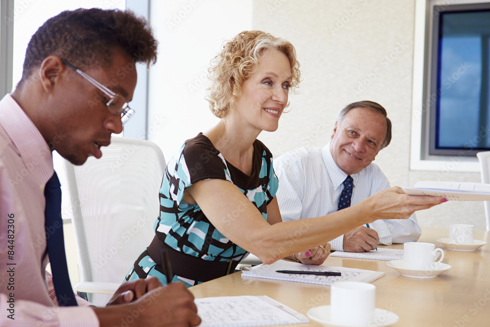 Three Businesspeople Having Meeting In Boardroom Three Businesspeople Having Meeting In Boardroom