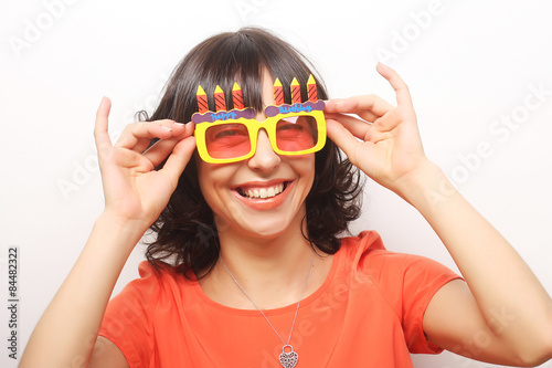 young happy woman with big orange sunglasses