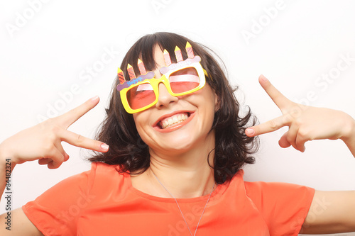 young happy woman with big orange sunglasses