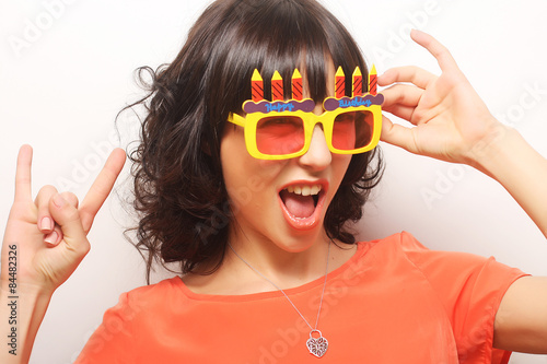 young happy woman with big orange sunglasses