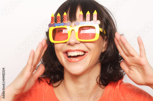 young happy woman with big orange sunglasses