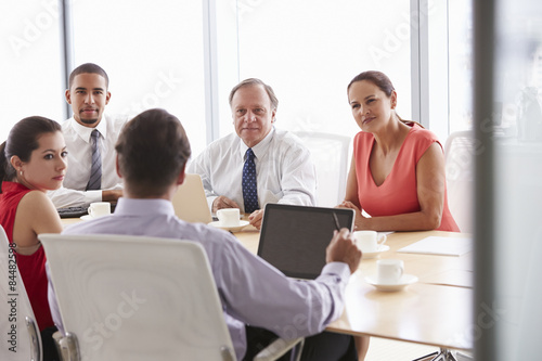 Five Businesspeople Having Meeting In Boardroom