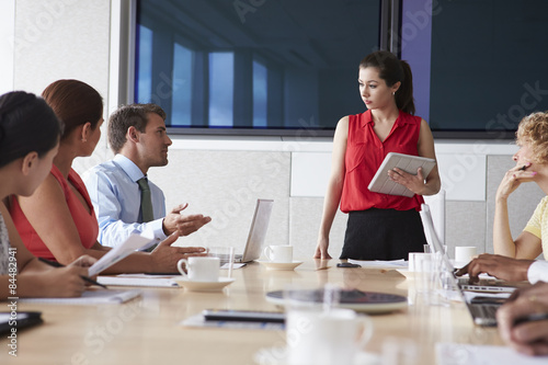 Group Of Businesspeople Meeting Around Boardroom Table