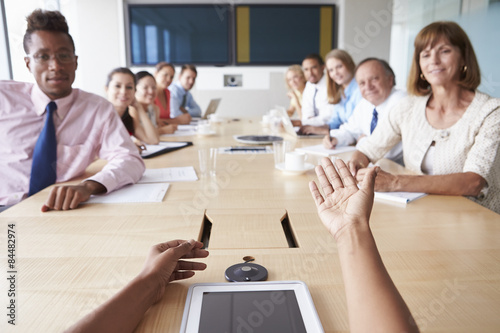 Point Of View Shot Of Businesspeople Around Boardroom Table photo