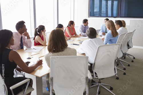 Group Of Businesspeople Meeting Around Boardroom Table