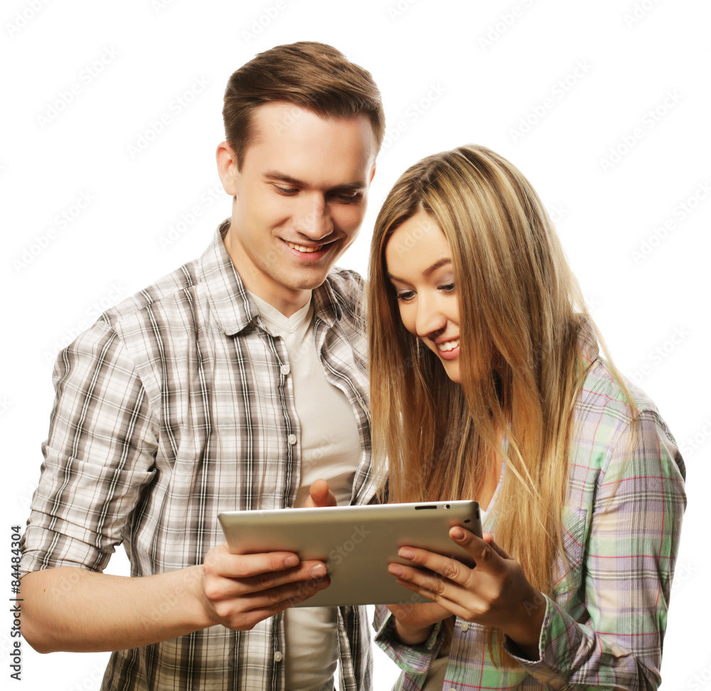 happy young couple holding tablet pc computer 