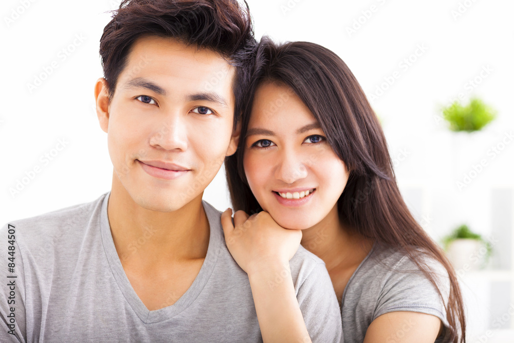 Young happy couple hugging and smiling Young happy couple hugging and smiling